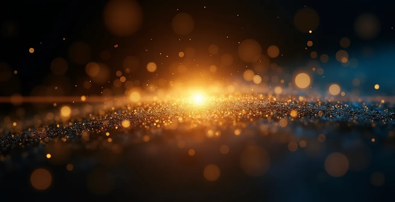 Vue macro de particules lumineuses dorées flottant dans l'air représentant la transformation de l'énergie mentale