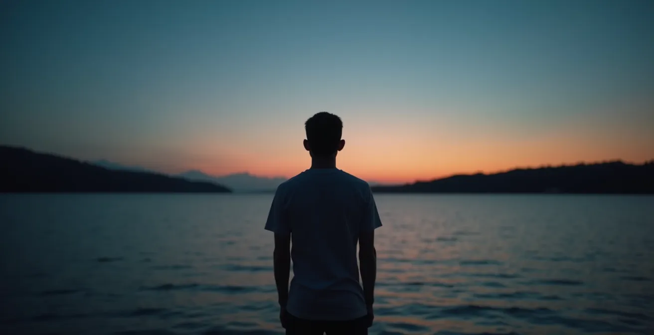 Chemin de pierres traversant une rivière calme symbolisant la progression vers l'autonomie
